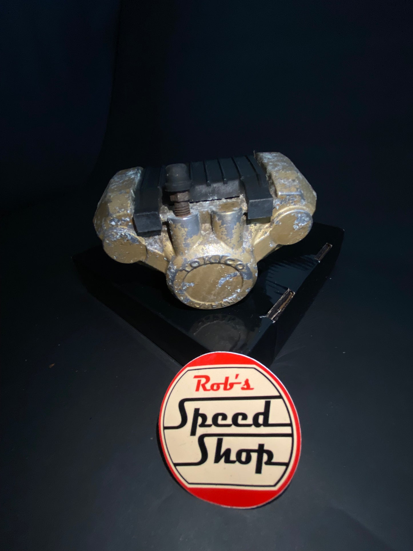 RG500 / RG400 rear caliper, hangar, and torque rod.