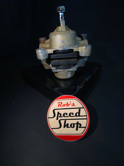 RG500 / RG400 rear caliper, hangar, and torque rod.