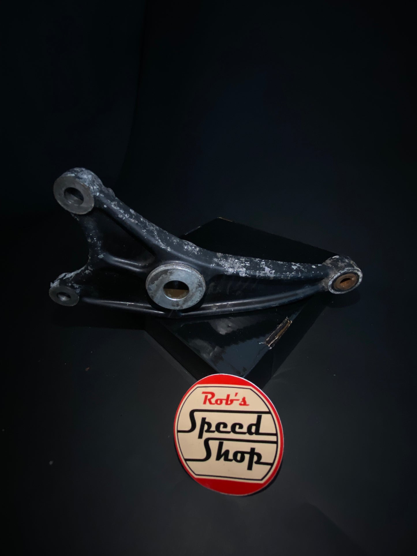 RG500 / RG400 rear caliper, hangar, and torque rod.