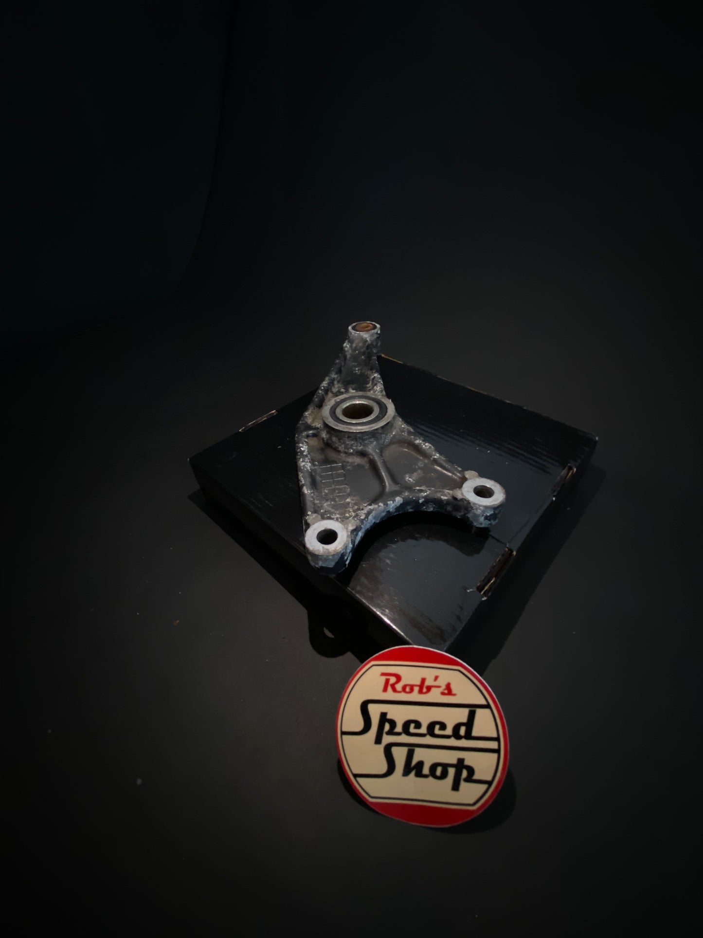 RG500 / RG400 rear caliper, hangar, and torque rod.
